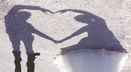 man and woman forming heart shadow thumbnail