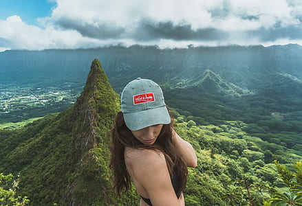 woman in black sports bra taking selfie on top of mountain with nature background thumbnail