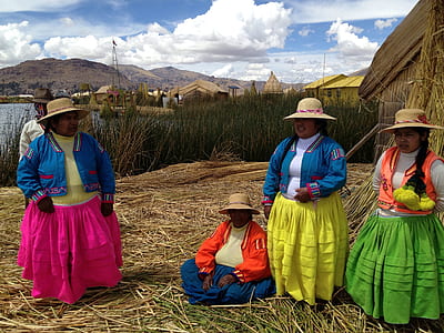 four women wearing assorted-color dresses thumbnail