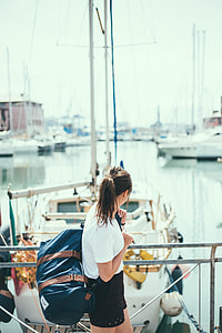 shallow focus photography of woman in white top standing thumbnail
