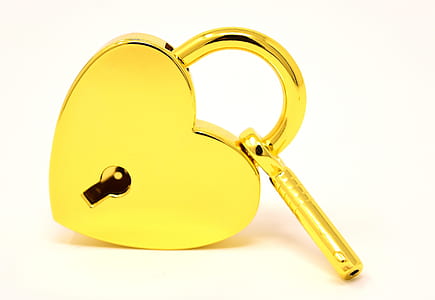 heart-shaped deadbolt lock with key on white surface thumbnail