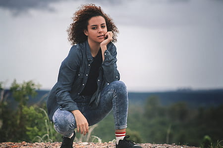 woman squatting on beige dirt during daytime thumbnail