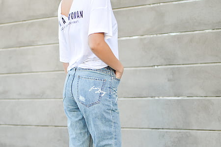 woman standing facing gray wall thumbnail