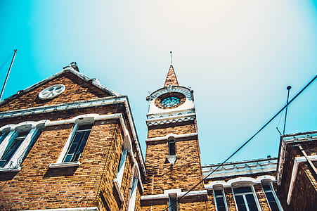photo of brown bricked building during daytime thumbnail