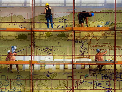 Four People Painting Wall on Scaffolding thumbnail