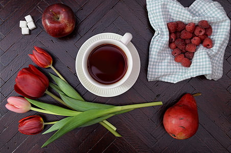 red flowers beside cup of tea thumbnail