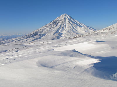 mountain covered in snow under blue sky thumbnail