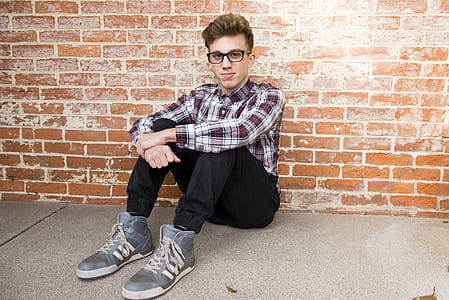 Man In Plaid Dress Shirt Sitting thumbnail