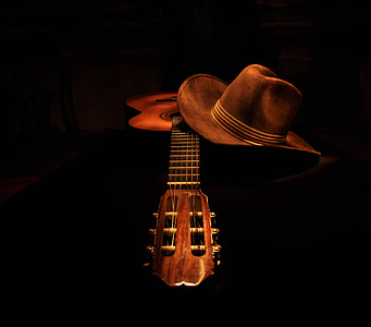 brown classical guitar and cowboy hat thumbnail