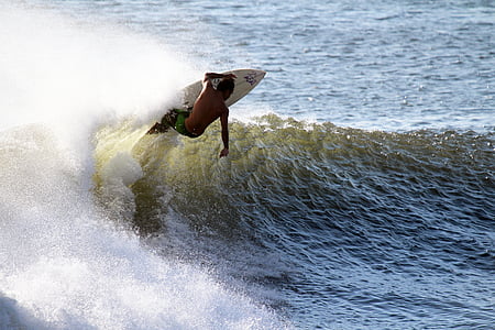 man riding on white surfing board thumbnail