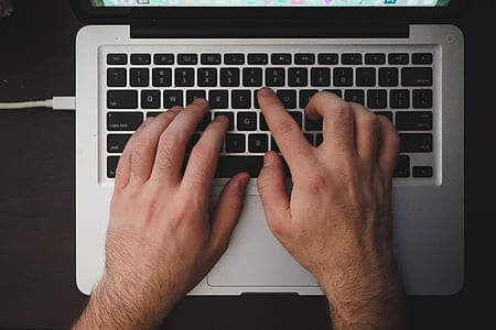 person's hand on MacBook Pro thumbnail