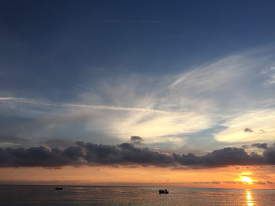 boat on white under white clouds and blue sky during sunset thumbnail