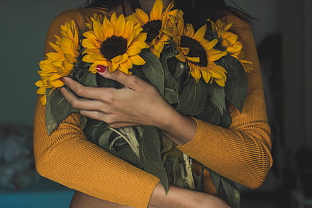 Woman Carrying Bunch Of Sunflowers thumbnail