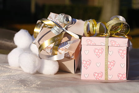 pink gift box beside white cotton balls thumbnail