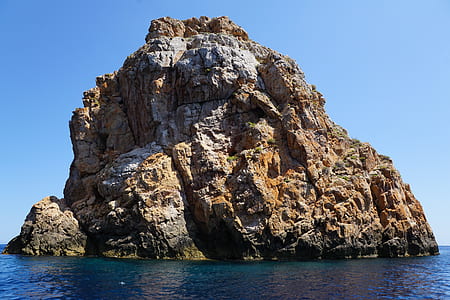 rock formation surrounded with water photo thumbnail