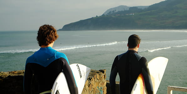 two man holding surfboards thumbnail