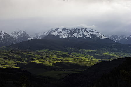 green grass field near mountain alps thumbnail