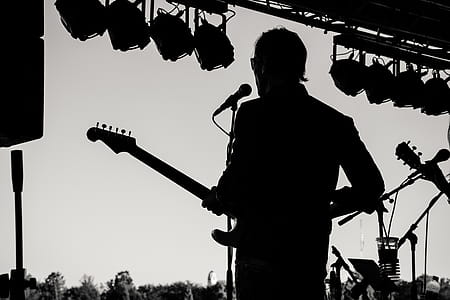 Silhouette Photo of Man Holding Guitar thumbnail