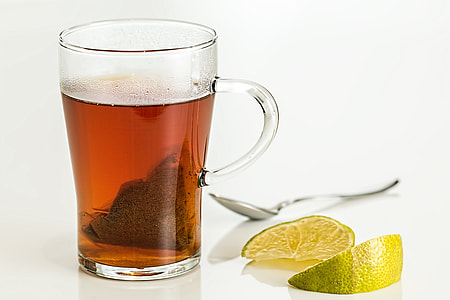 still life photography of clear glass mug filled with brown liquid thumbnail
