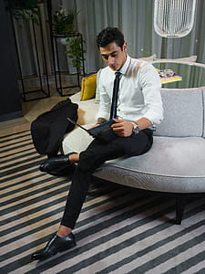 Man Sitting on Grey Couch thumbnail