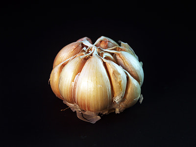 garlic bulb on black surface thumbnail