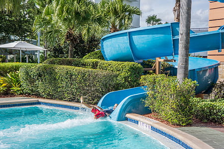 toddler playing on pool slide thumbnail