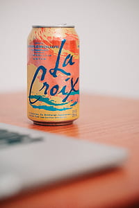 La Croix tin can on brown surface thumbnail