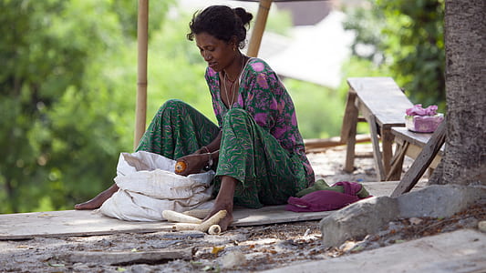 woman sitting beside white sack thumbnail