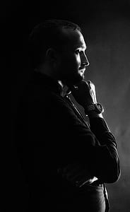 grayscale photo of man holding his chin thumbnail