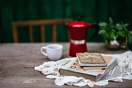 Stack of organizers and red italian coffee maker thumbnail