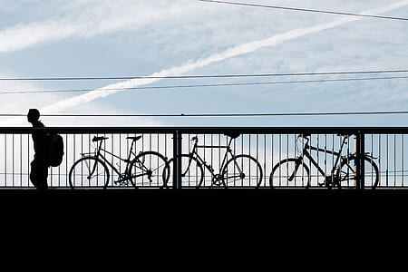 silhouette of man beside fence thumbnail
