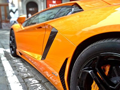 orange Lamborghini parked during daytime thumbnail