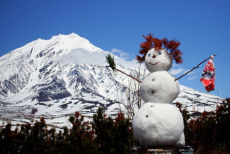 Snowman outdoor decor near mountain thumbnail
