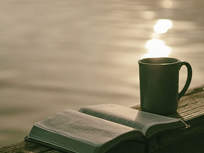 photography of book beside ceramic mug thumbnail