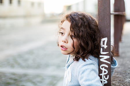 selective focus photography of girl wearing long-sleeved shirt thumbnail