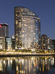 clear glass high-rise building near body of water thumbnail