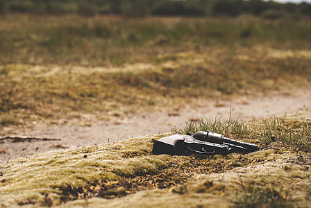 black revolver on brown surface thumbnail