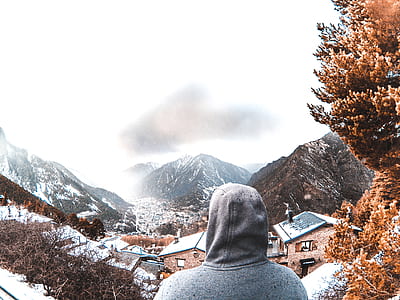 landscape photo of gray mountains covered with snow near brown house thumbnail