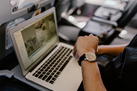 Unrecognizable man with notebook sitting inside an airplane thumbnail