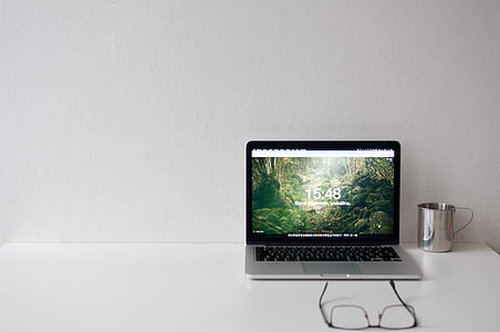 silver laptop computer near steel mug thumbnail