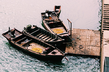 three brown wooden boats under water thumbnail