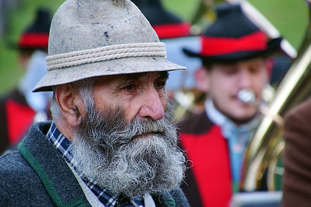 man wearing gray hat standing near marching band thumbnail