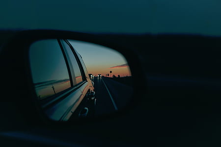 person taking photo on wing mirror thumbnail