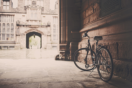photography of gray cruiser bicycle beside brown concrete wall thumbnail