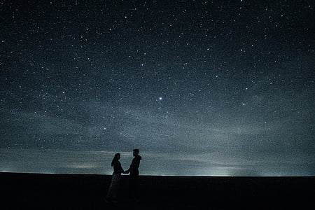 man and man holding each other's hands under starry night thumbnail