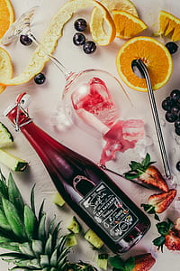 clear wine bottle and slice of orange thumbnail
