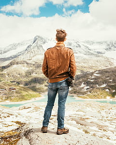 man standing while watching the mountain thumbnail