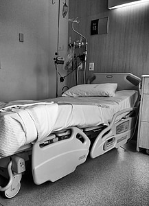 grayscale photography of hospital bed beside cabinet thumbnail