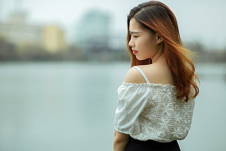 shallow focus photography of woman in white cold shoulder top thumbnail