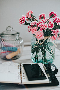 Organizer, mobile phone and lovely pink flowers thumbnail